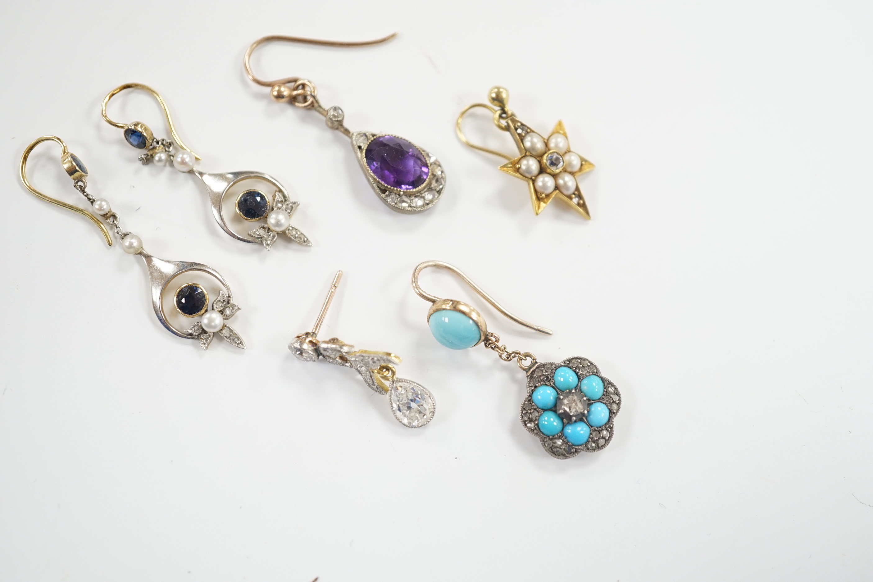 A group of four assorted Edwardian and later single earrings, including amethyst and diamond, turquoise and diamond, seed pearl and diamond cluster and pear shape diamond drop, 21mm and a pair of sapphire, seed pearl and